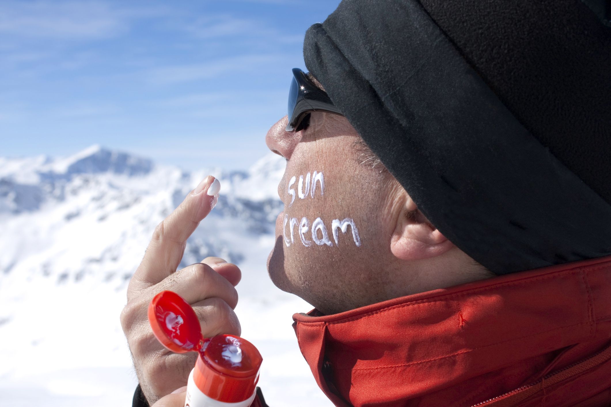 skier applying sun block