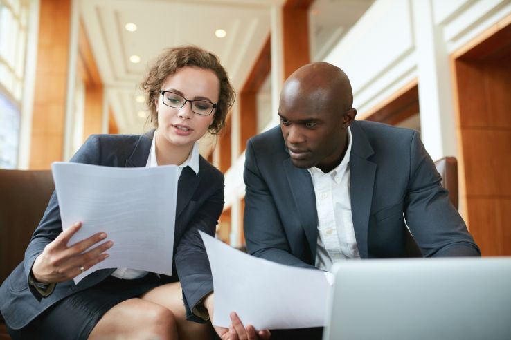 Man and woman reviewing sales leads