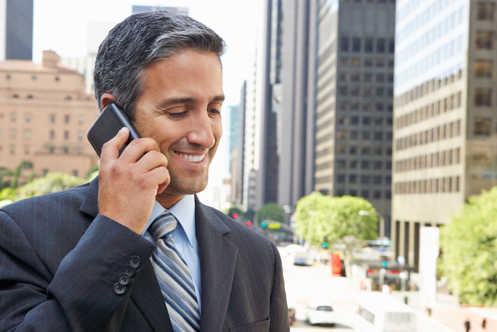 Businessman on a cellphone outside