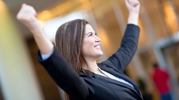 Business woman with raised arms