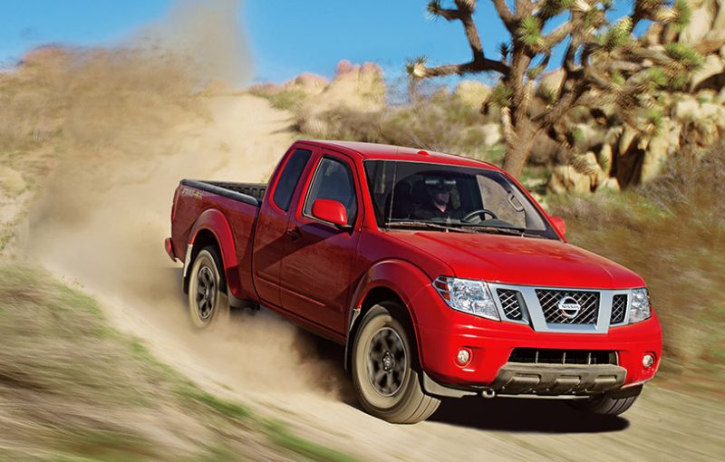 Nissan Frontier King Cab shown in Lava Red off-roading