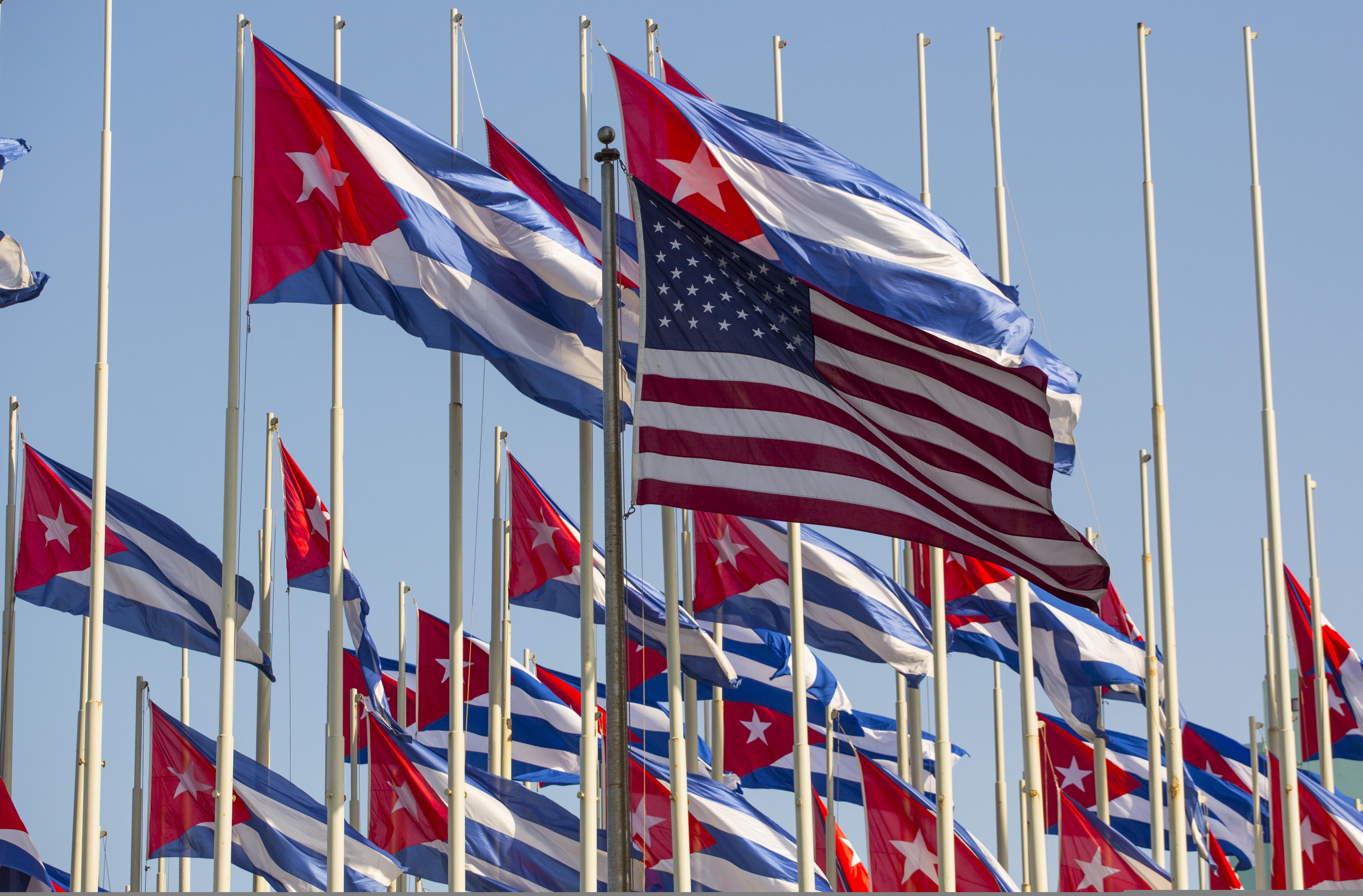 The U.S. flag flies outside the U.S. embassy near many Cuban flags hoisted on Revolution Day, in Havana, Cuba, Friday, Jan. 1, 2016. (AP Photo/Desmond Boylan)