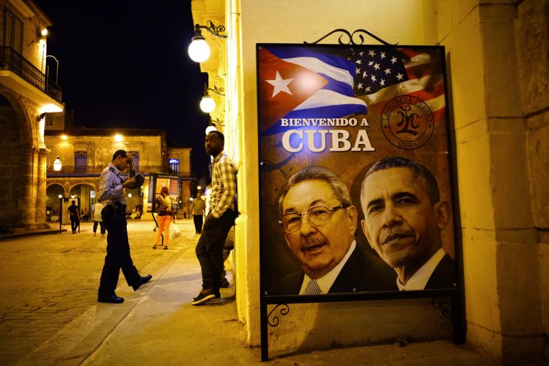 A poster features portraits of Cuba's President Raul Castro, left, and U.S. President Barack Obama and reads in Spanish "Welcome to Cuba" outside a restaurant in Havana, Cuba, Thursday, March 17, 2016.