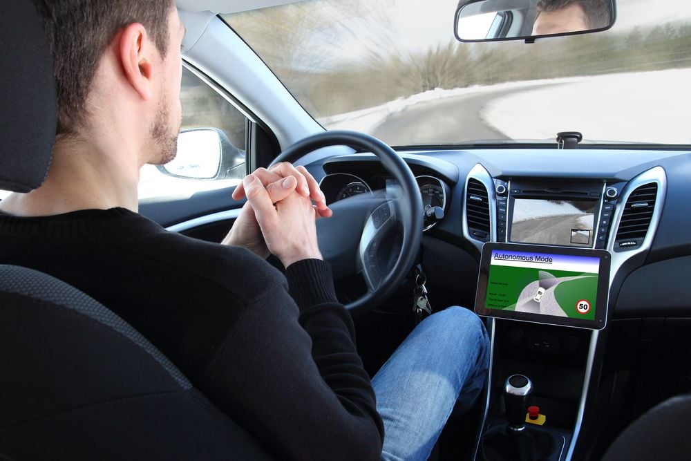 man behind the wheel of a self-driving vehicle