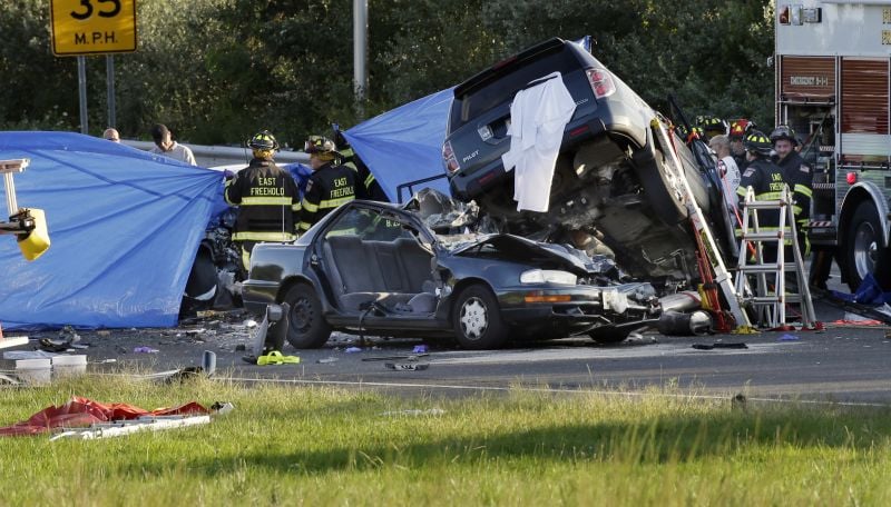 Police and firefighters work at a crash scene