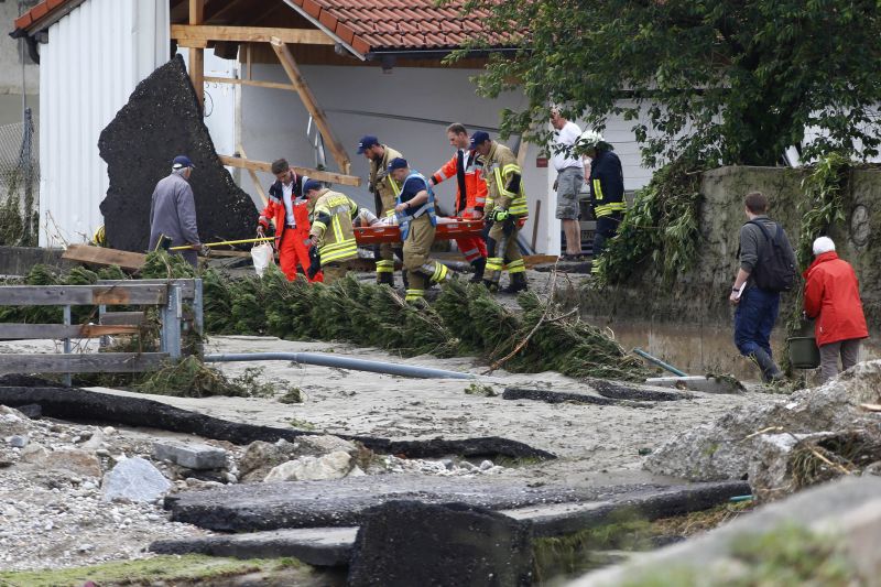 Fire fighters and red cross employee carry a woman from her flooded home after the small town was hit by flooding in Simbach am Inn, Germany