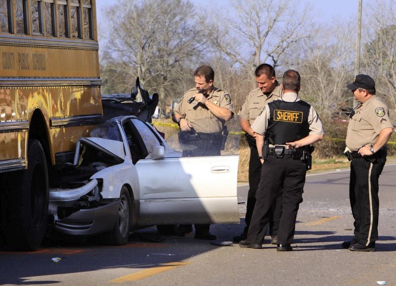 Mobile County Sheriff Deputies examine a car involved in an early morning accident that killed 16-year-old LaDonna Perryman, who was driving on Old Pascagoula Road