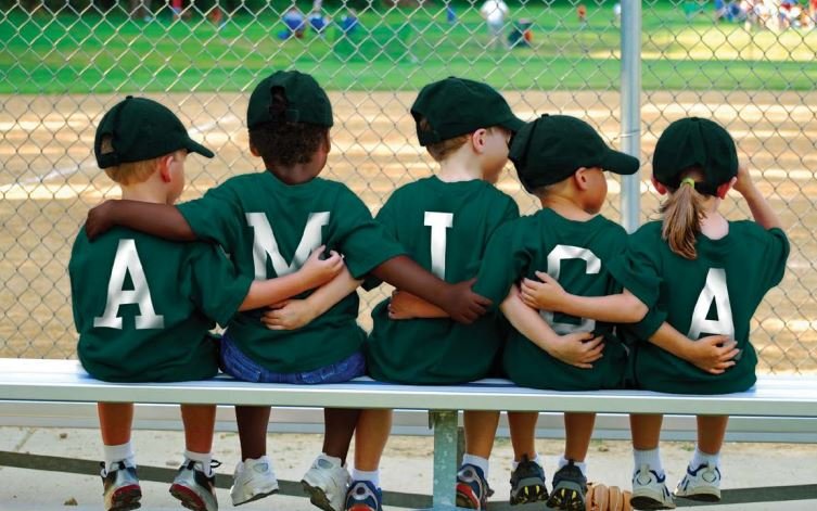 boys at baseball diamond spelling Amica on back of shirts