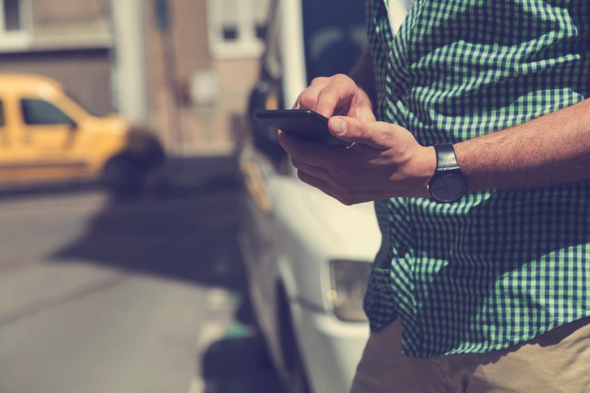 Walking into a street carrying a mobile phone