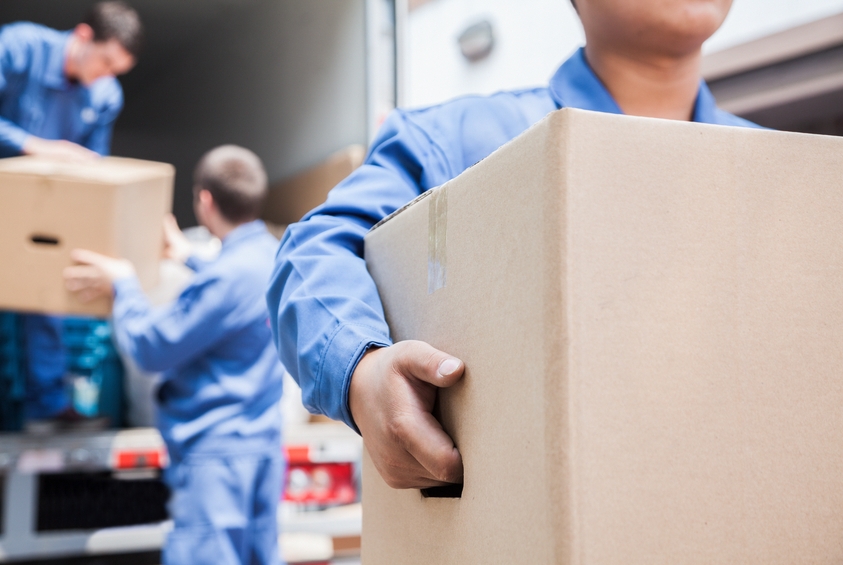 Movers taking boxes with handles off truck