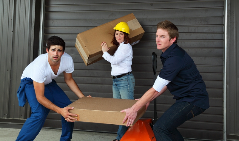 Two men carrying box unsafely