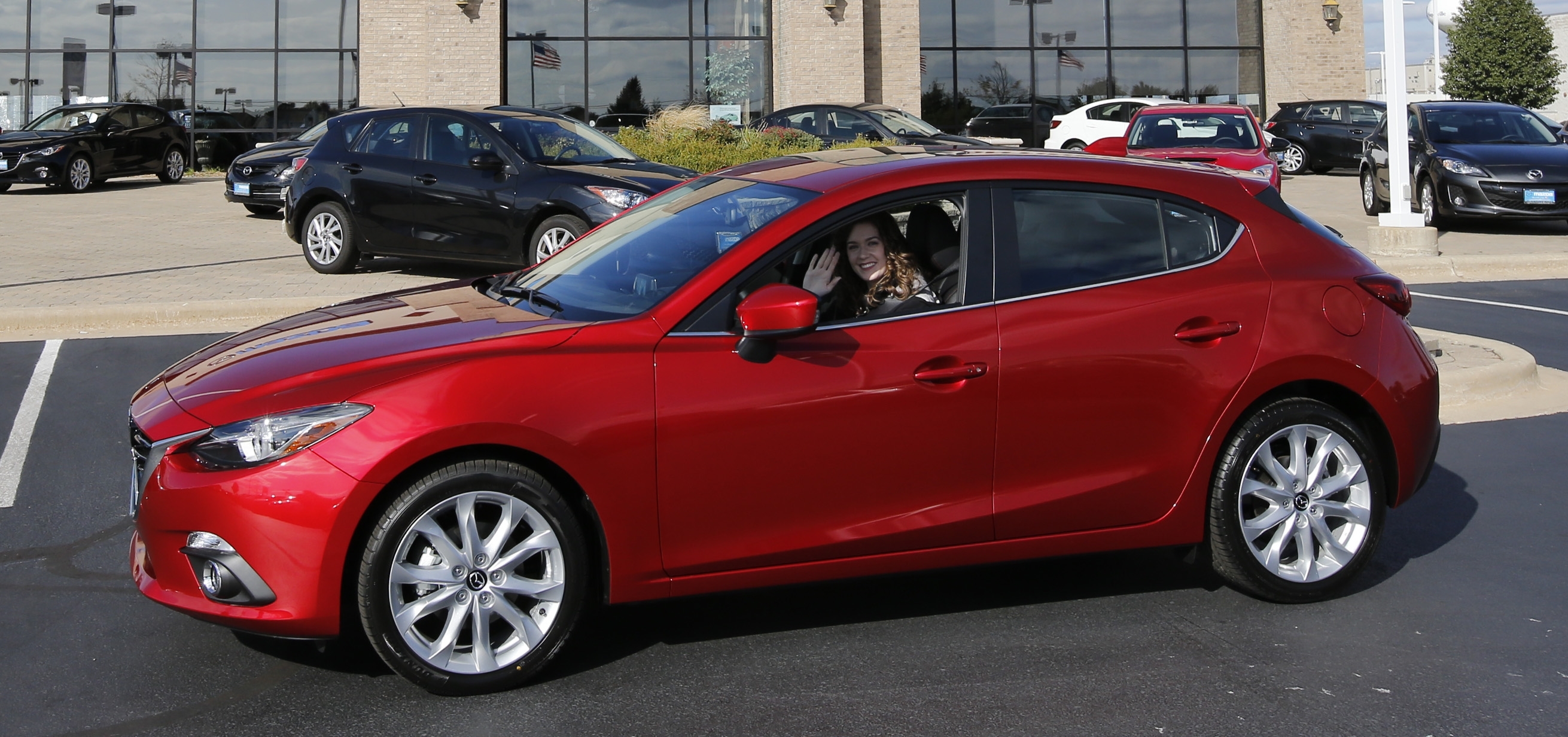 Mazda 3S with woman driver