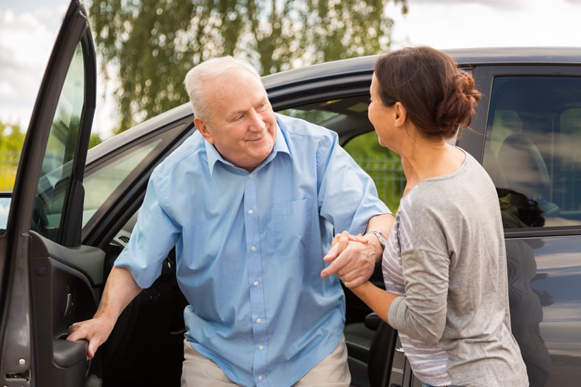 Man being helped from vehicle