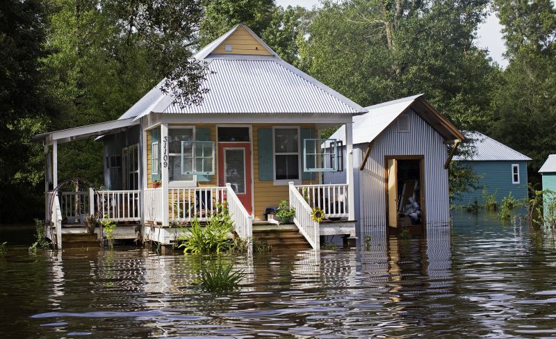 Floodwaters reach the front steps of a home near Holden, La.