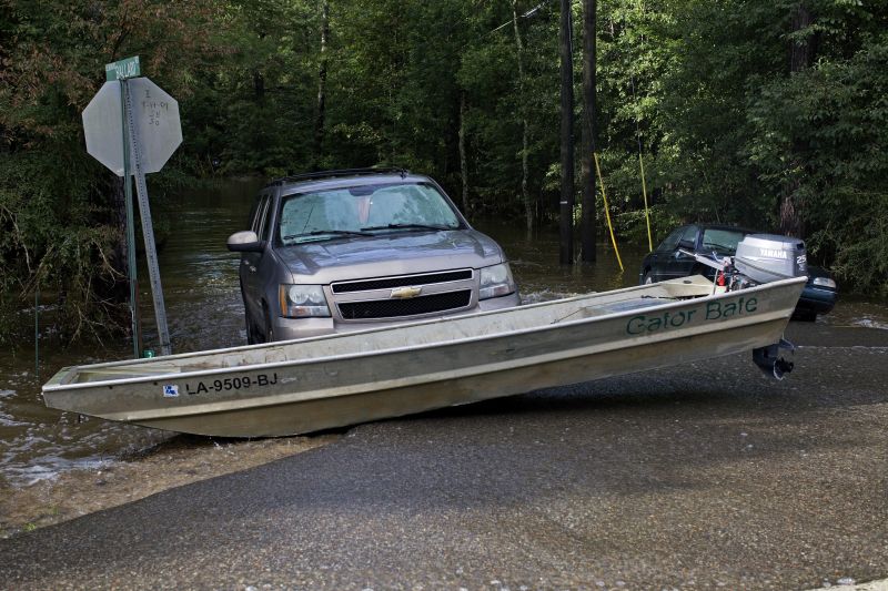 A boat and vehicle are seen abandoned at a road west of Tickfaw, La.