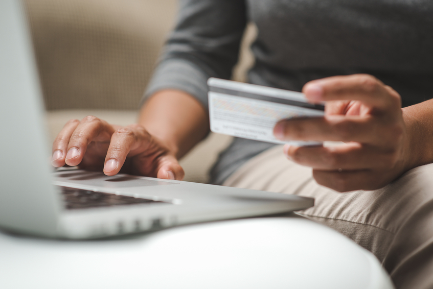 Man making purchase with credit card on laptop