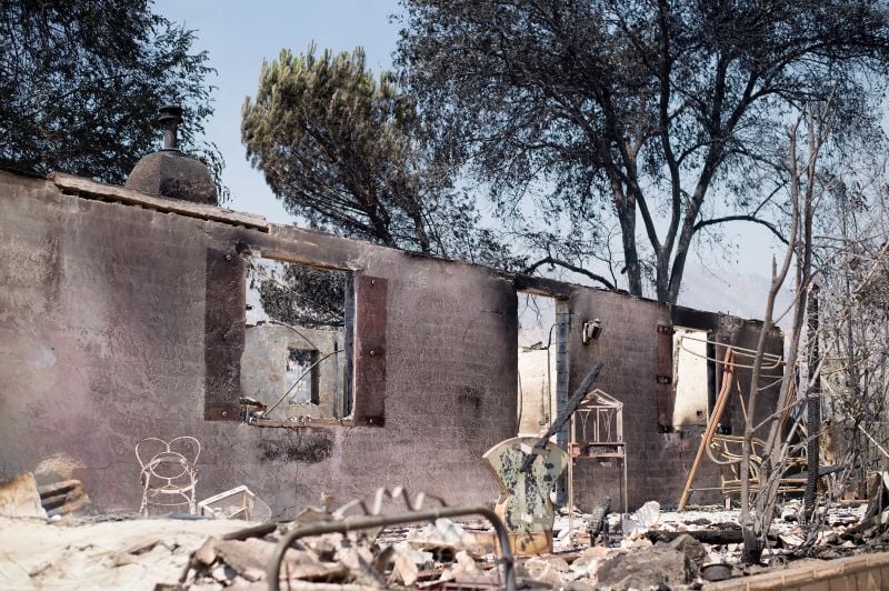 burned out residence stands amid rubble