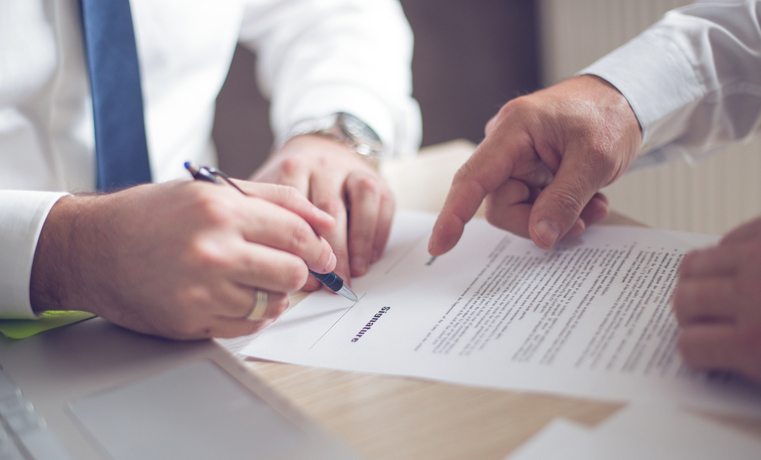 Business men's hands signing document