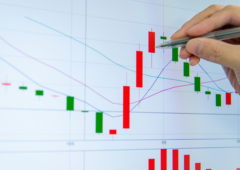 Man's hand drawing data points on board