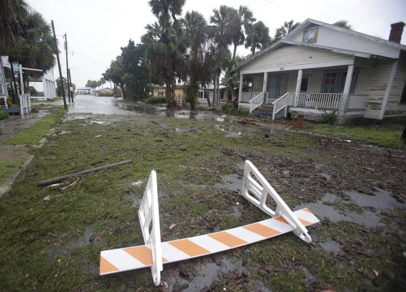 Seaweed covers a flooded street in Cedar Key, Fla. as Hurricane Hermine nears the Florida coast, Thursday, Sept. 1, 2016. 