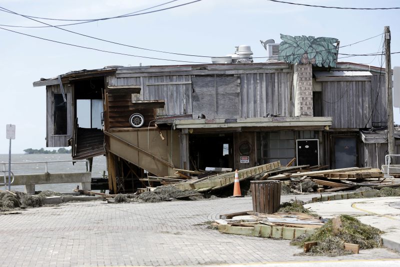 Debris lies near a waterfront building damaged by Hurricane Hermine Friday, Sept. 2, 2016, in Cedar Key, Fla.