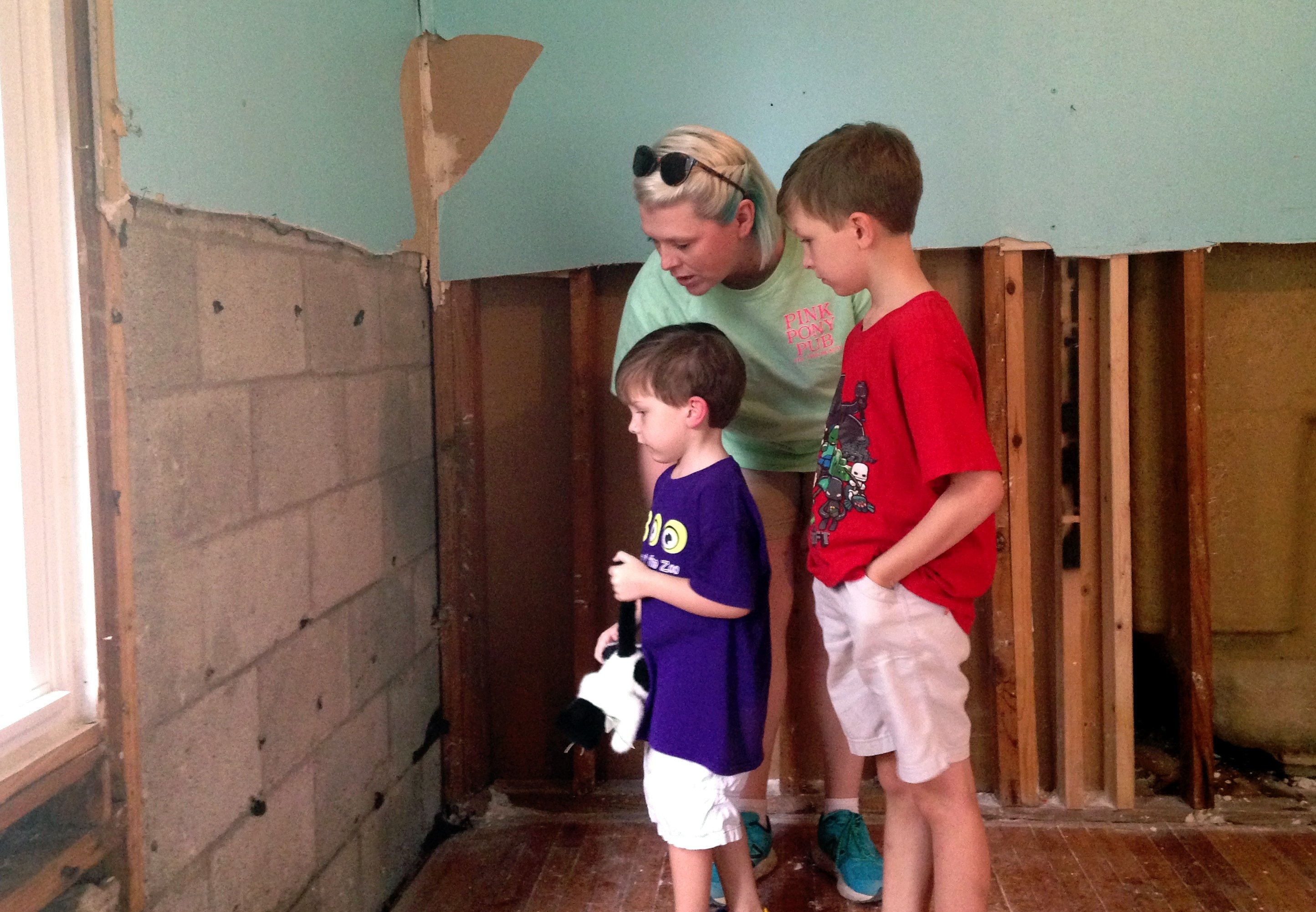 Family looking at flood damage Louisiana