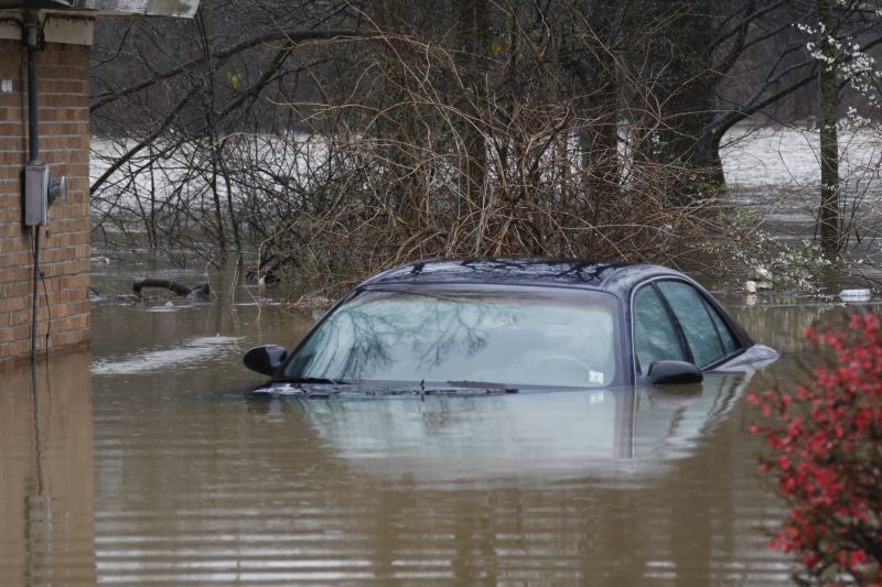 A sedan sits underwater 