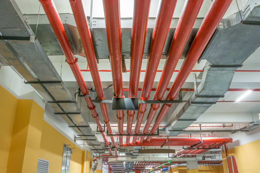 Close up of sprinkler system in warehouse