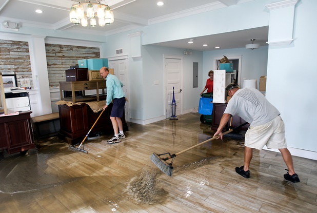 Men cleaning office after flood