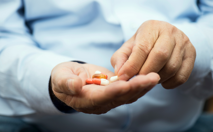 Man holding pills