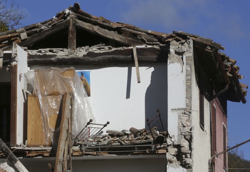 A bedroom was left in open air in a severely damaged house in the small town of Visso, Italy