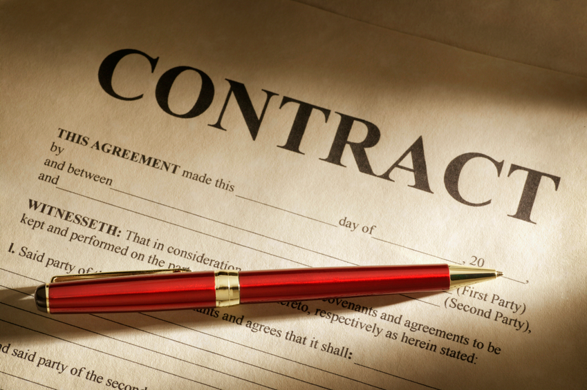 Paper contract with red pen