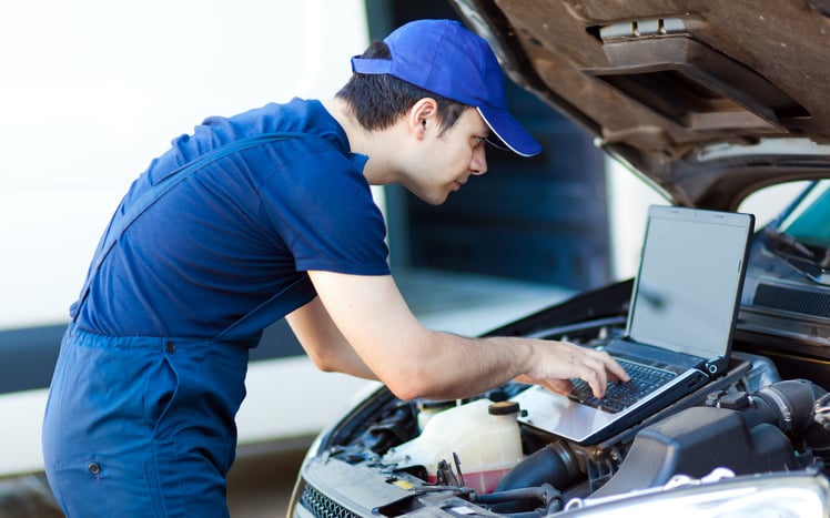 technician scanning car motor