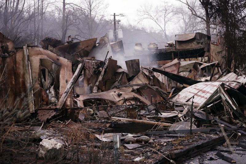 Smokes rises out of the remains of a burned-out business