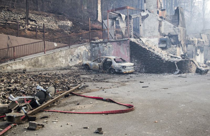 scorched vehicle and burned building