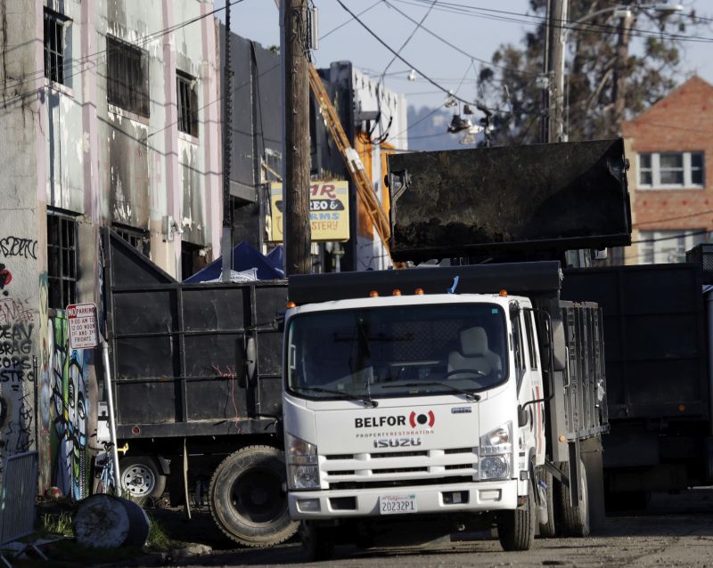 Cleanup continues at the scene of a warehouse fire