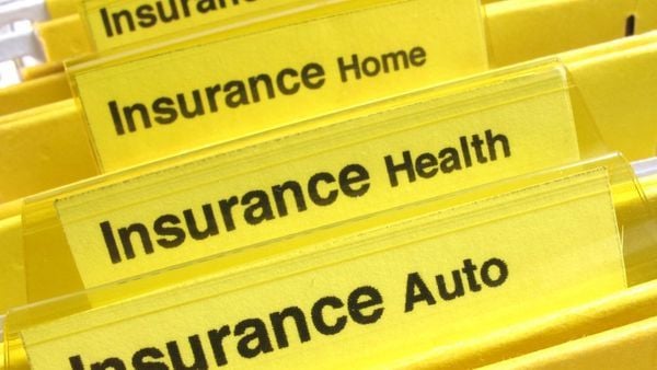 Yellow file folders with different kinds of insurance labels