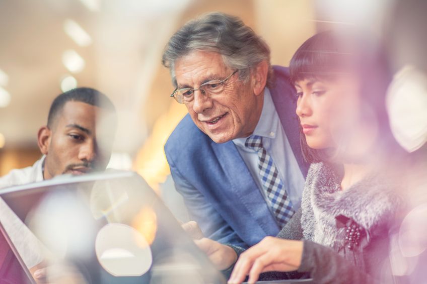 boss viewing young employee's work