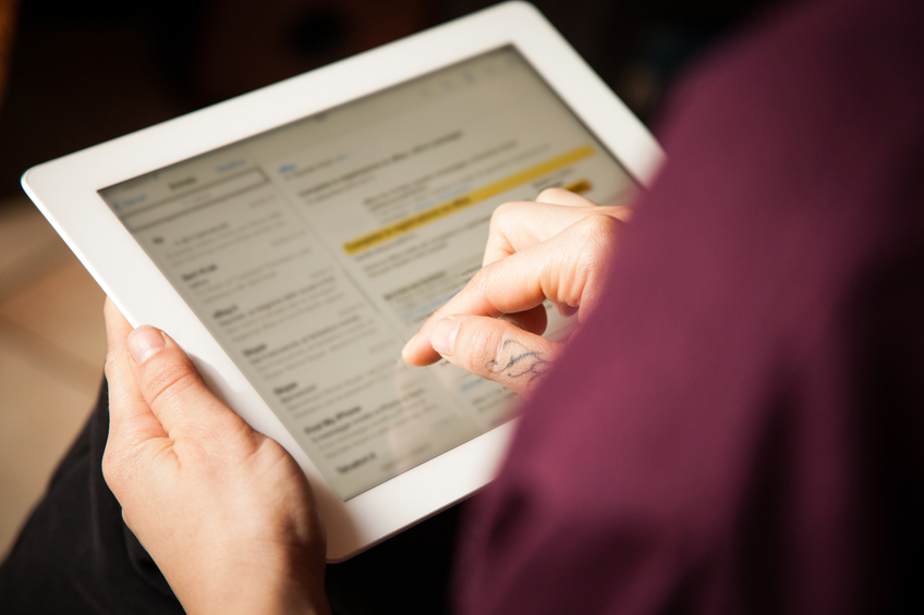 person checking email on an iPad