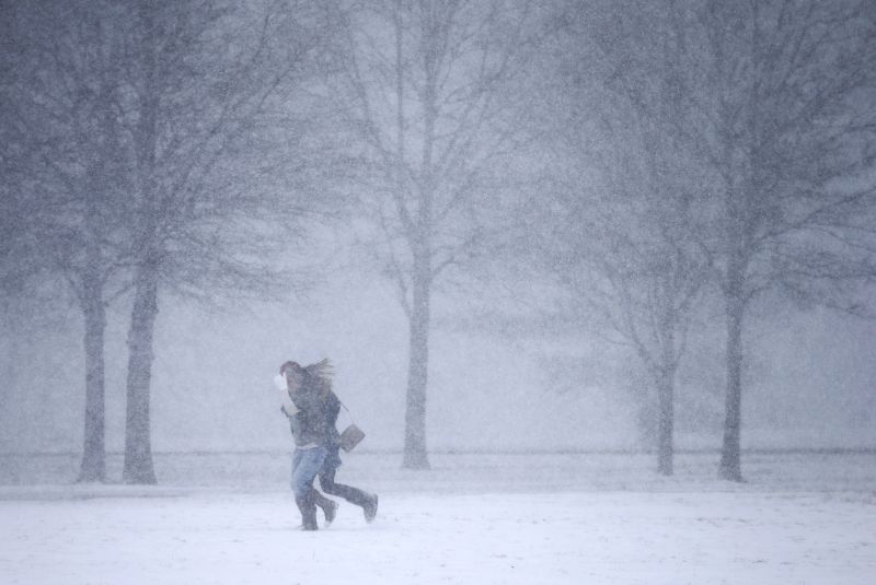 Two women run through a snow flurry in Nashville