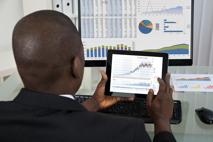 Back of African-American man analyzing financial data