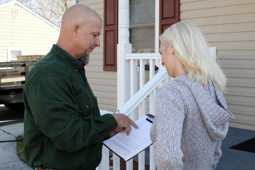 Insurance adjuster talking to policyholder