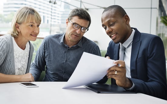 Mature couple meeting with young African American insurance agent advisor