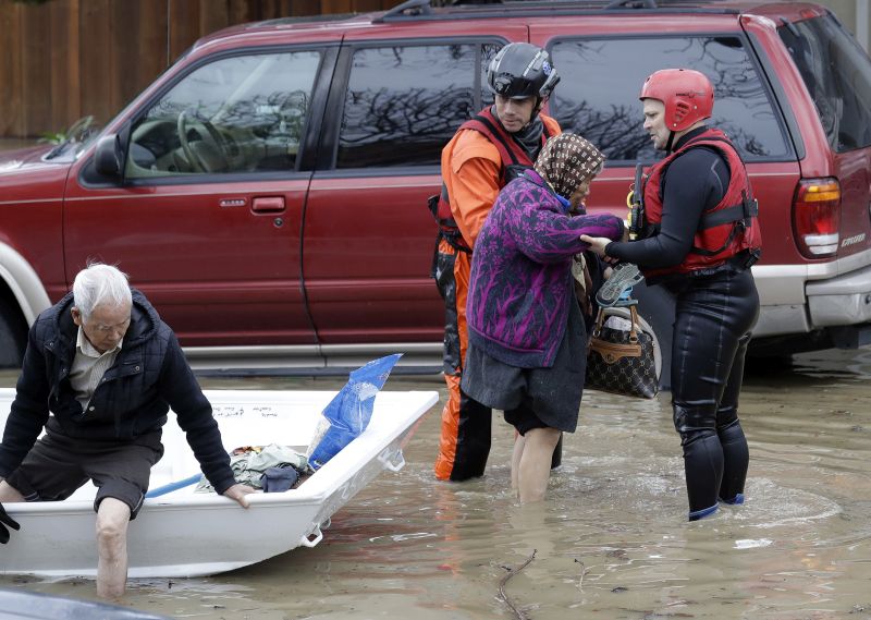 rescue crews help elderly flood victims