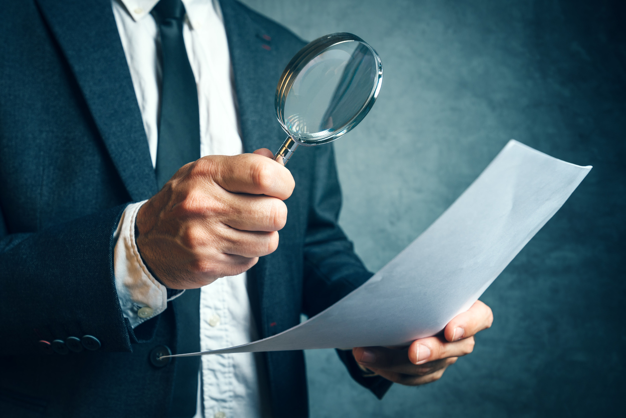 person checking something with a magnifying glass