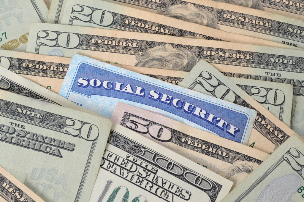 social security card hidden among paper money