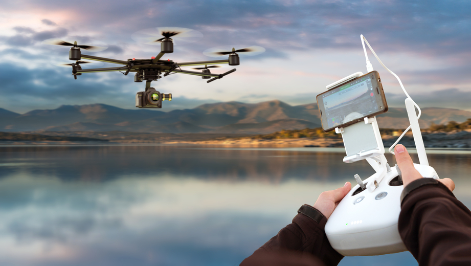 operator flying a drone over water