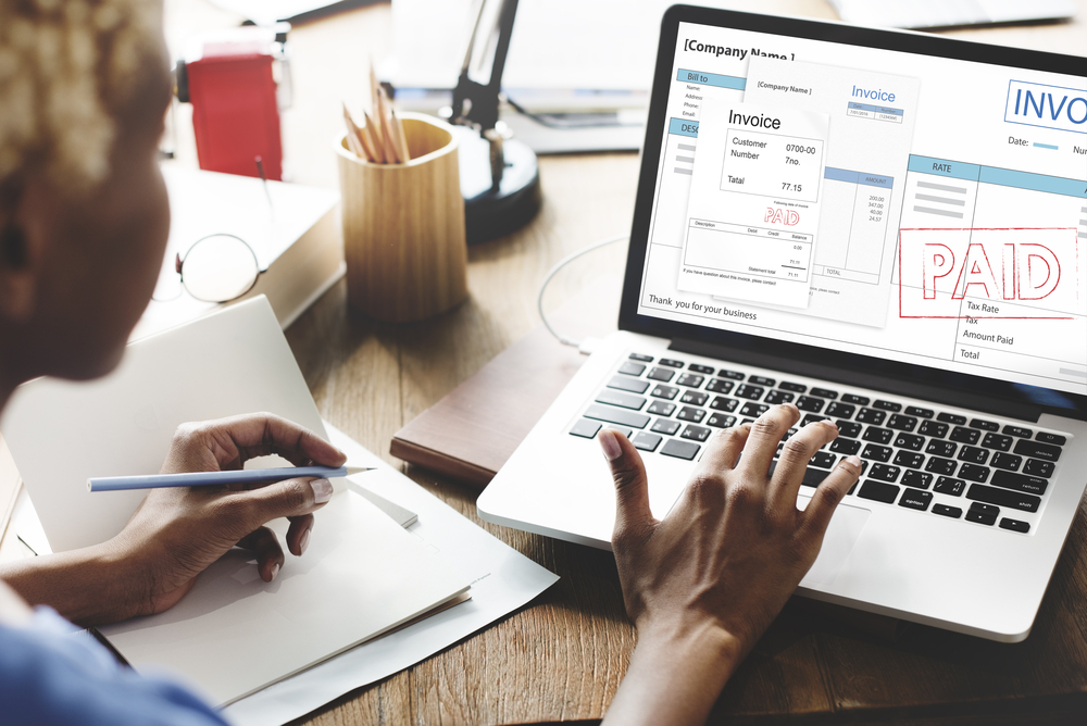 man checking invoices on computer