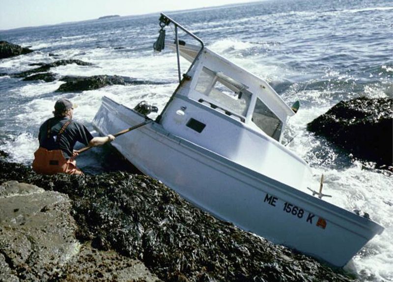 boat wrecked on rocks