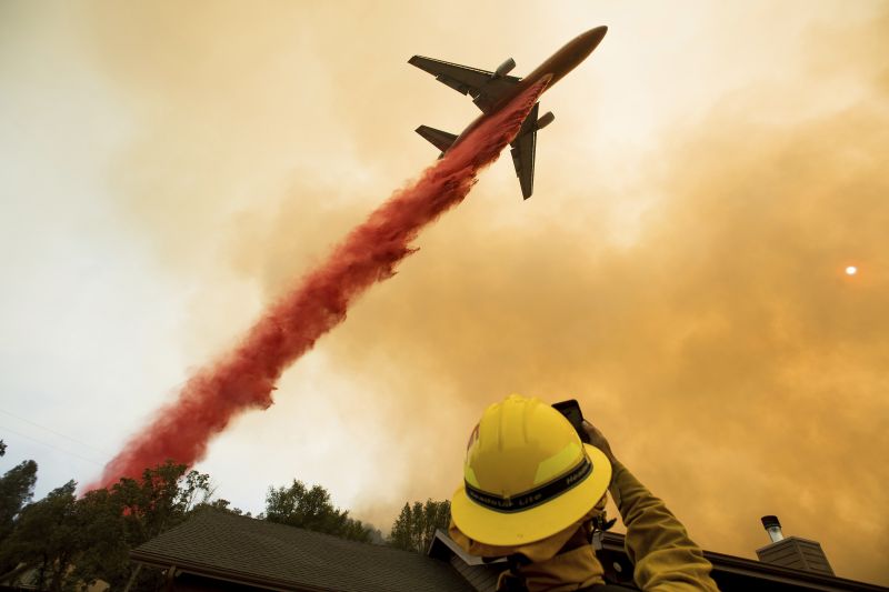 An air tanker drops retardant while battling a wildfire near Mariposa, Calif